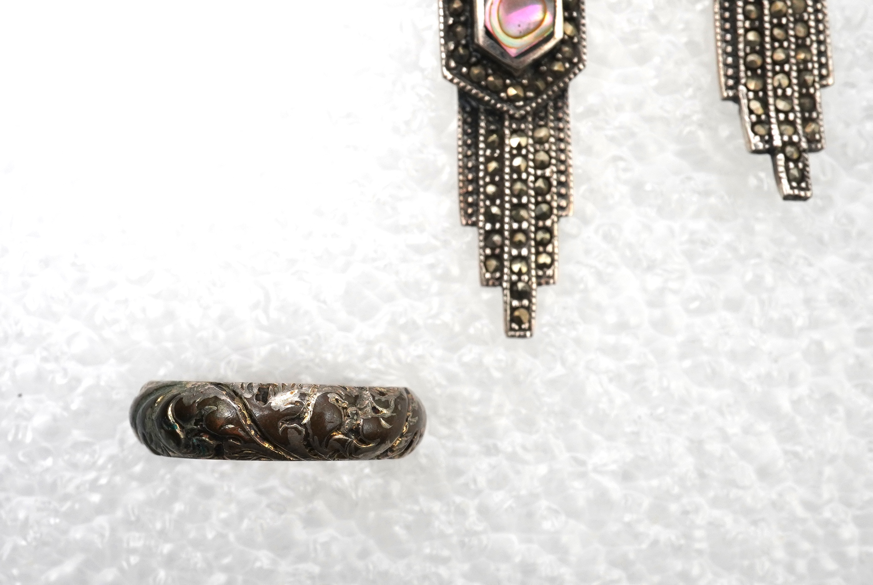A small collection of costume jewellery to include a silver curb link charm bracelet, hung with assorted bezel set agate and carnelian drops, together with other silver and costume jewellery